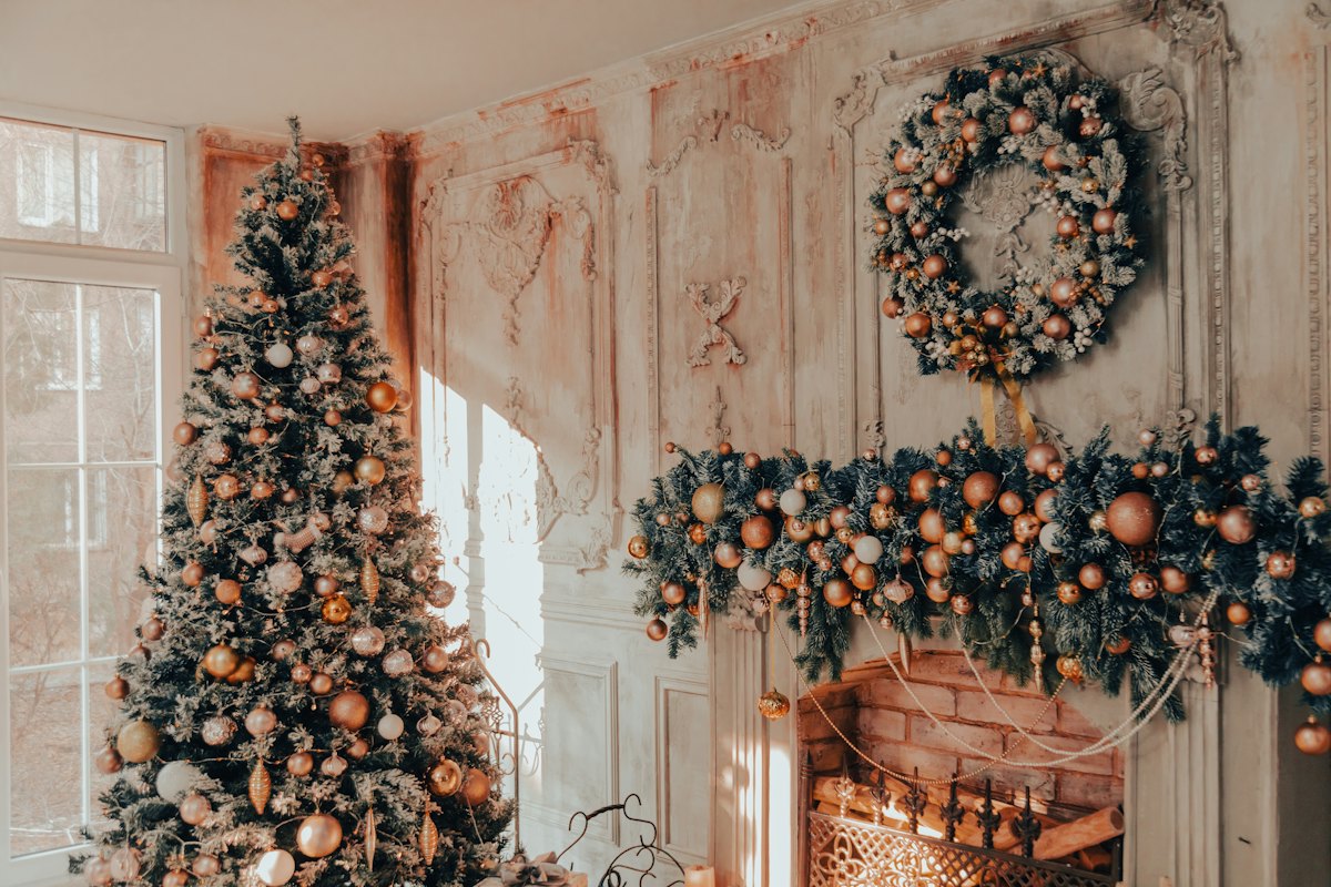 Living room decorated for Christmas with a fireplace and tree
