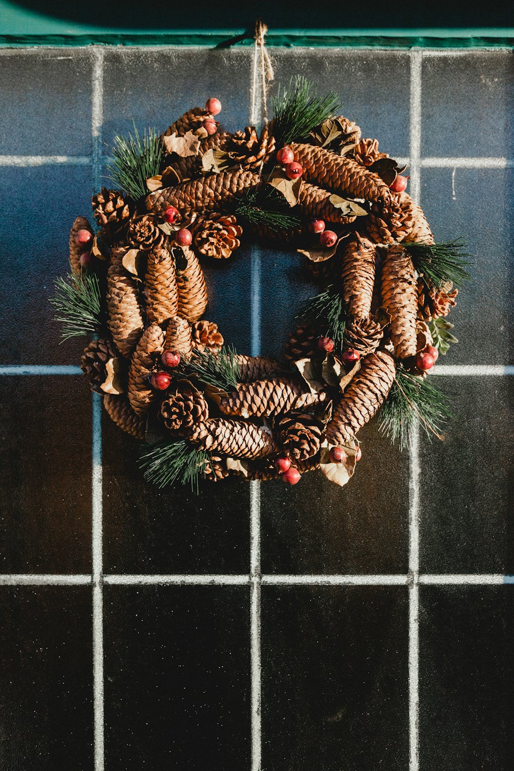 Lit holiday wreath hanging on a front door